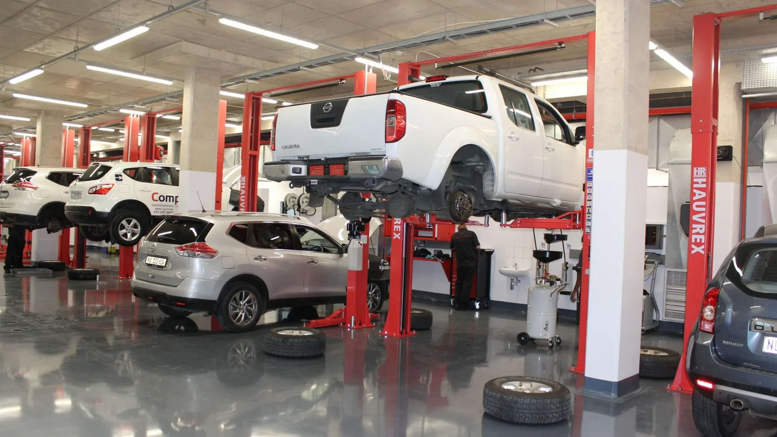Vehicle lifts in operation across a dealer workshop equipped by Equiptech